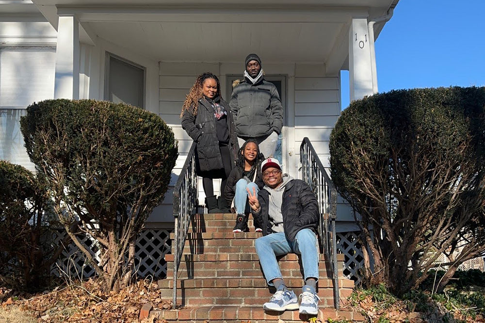 A photo of Arlyce Porcher Joseph and family, who used an affordable mortgage and MassDREAMS grant from MassHousing to purchase their first home.