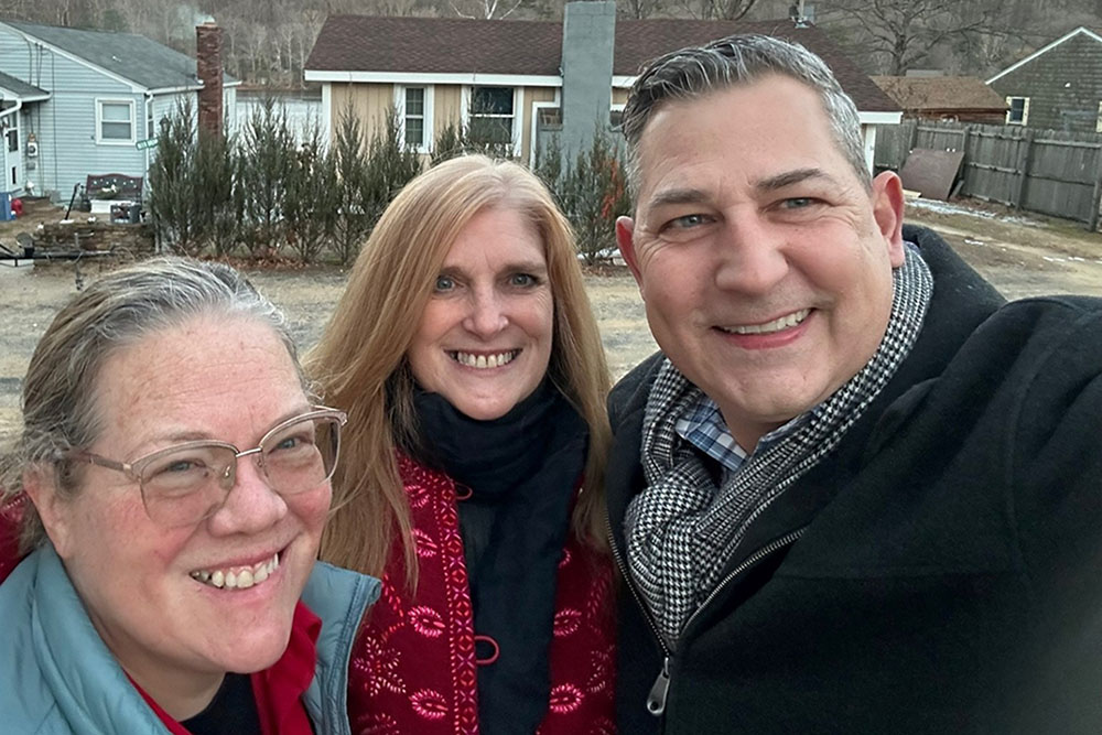 A photo of Michelle W., MassHousing home mortgage borrower and MassDREAMS grant recipient, with Realtor Jeanne Crowley and loan officer Rick Simoneau