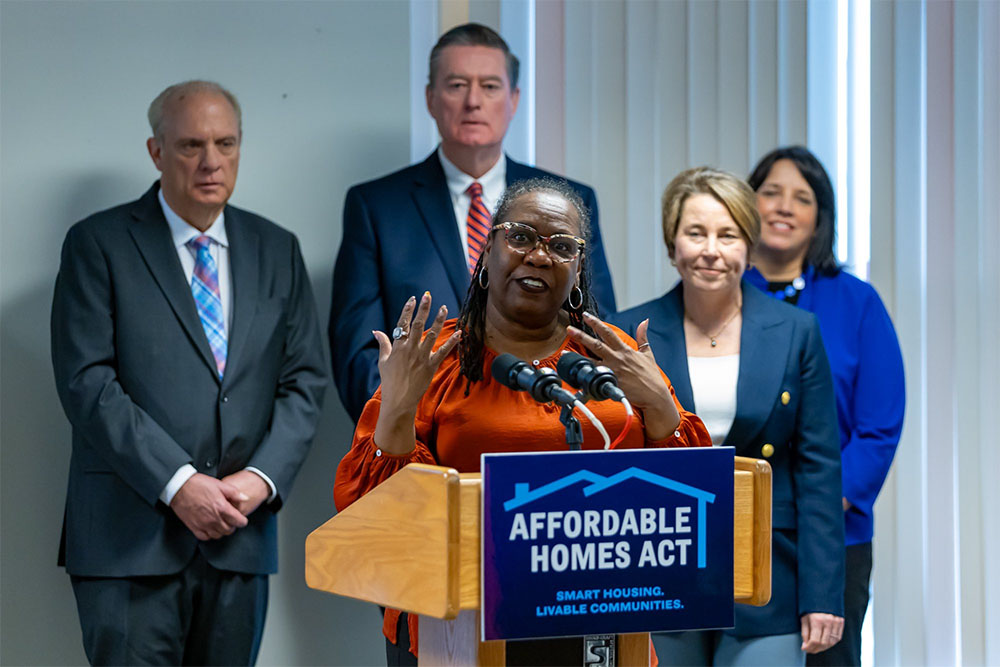 A photo of MassHousing CEO Chrystal Kornegay speaking at the announcement of the Commercial Conversion Initiative, as Governor Maura Healey, Lt. Governor Kim Driscoll, EOHLC Secretary Ed Augustus and Worcester Mayor Joseph Petty look on. Photo courtesy of the Office of Massachusetts Governor Maura Healey.